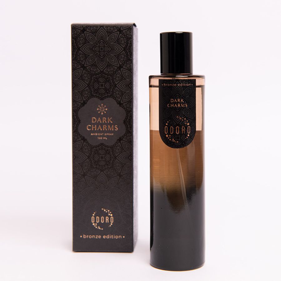 DARK CHARMS spray fragrance bottle alongside its luxurious packaging box on a white background, showcasing the elegant design of both.