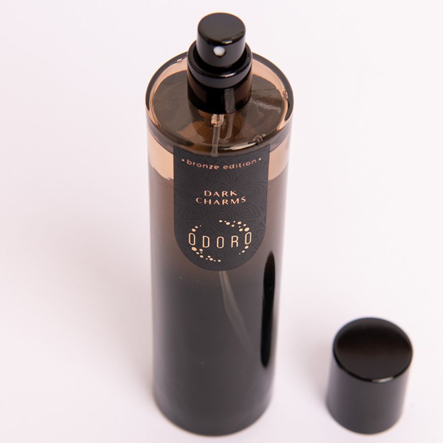 Open DARK CHARMS spray fragrance bottle on a white background, highlighting its luxurious scent and elegant design