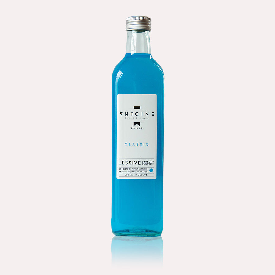 Antoine Classic perfumed laundry detergent in a clear glass bottle against a plain background.