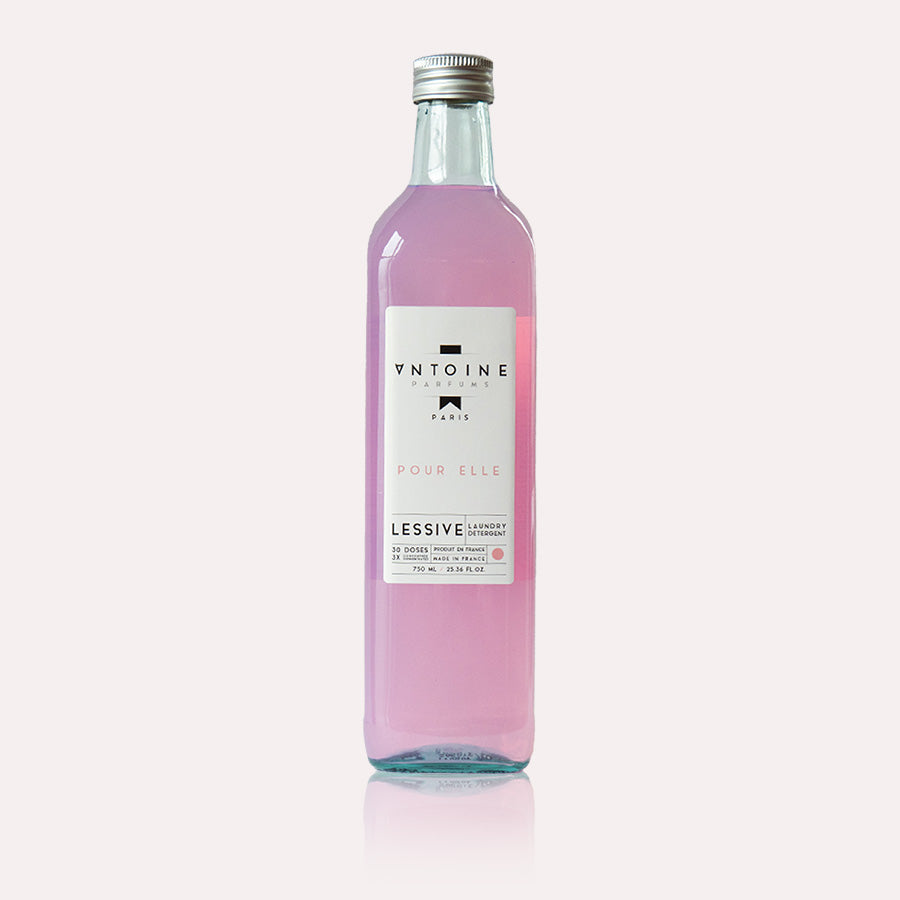 Antoine Pour Elle perfumed laundry detergent in a recyclable glass bottle, highlighting its soft and elegant floral fragrance.
