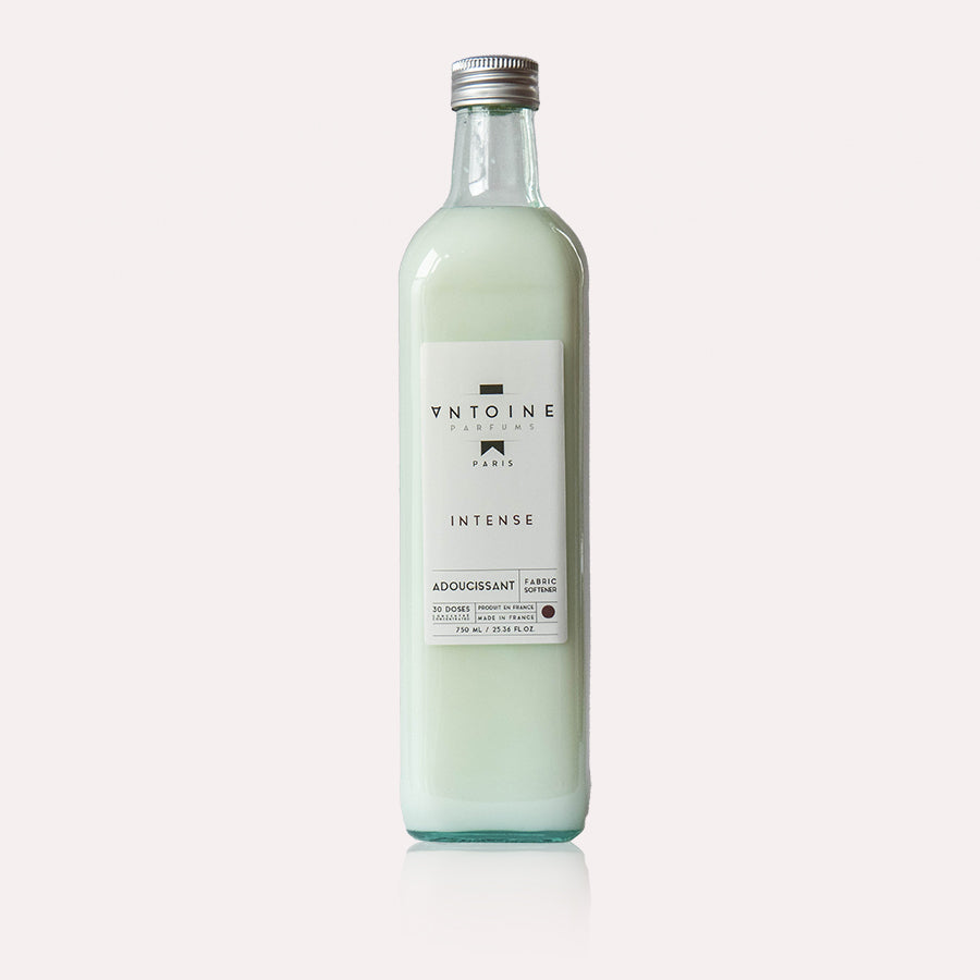Antoine Intense fabric softener in a recyclable glass bottle, showcasing its minimalist and elegant packaging.