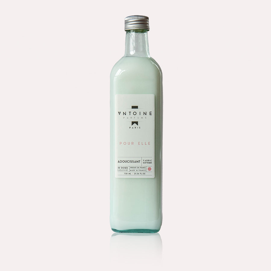 Antoine Pour Elle fabric softener product shot in a minimalistic clean background, highlighting the eco-friendly glass packaging.