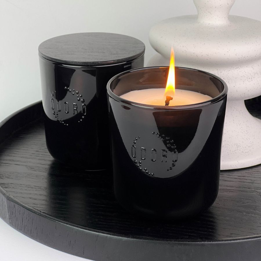 Pair of Magnolia candles with wooden lids burning on black tray