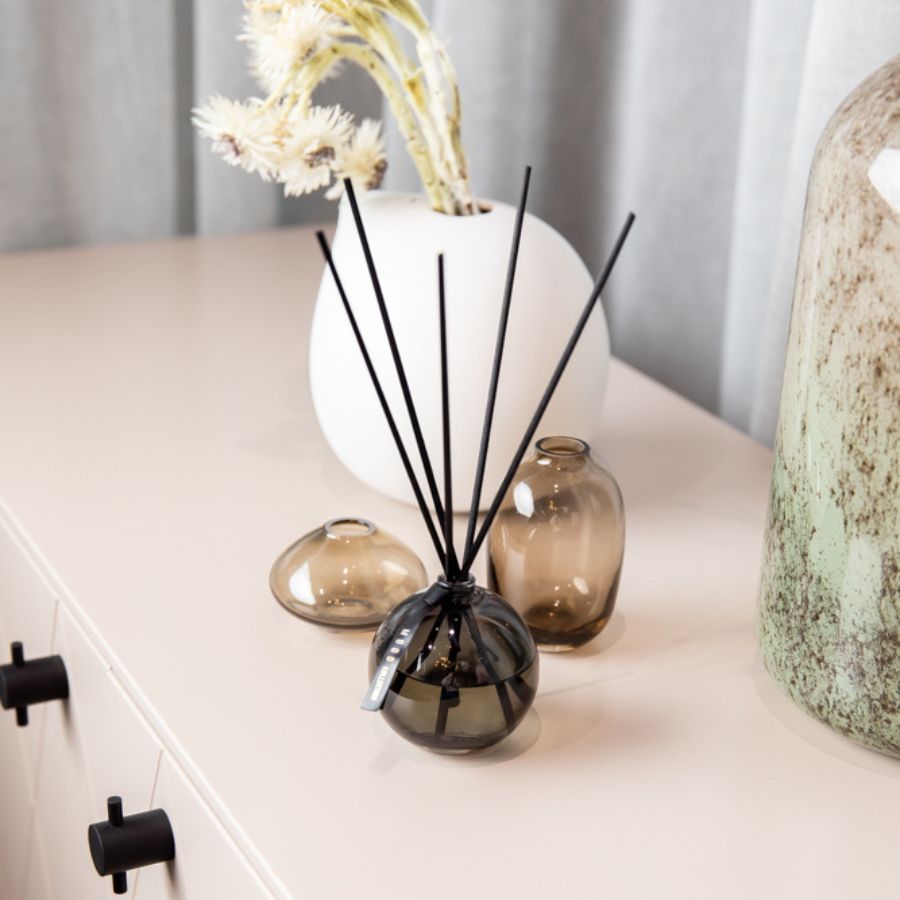 Elegant diffuser from ODORO Mood Collection placed on a modern interior table, surrounded by decorative vases and adding a touch of sophistication to the room.