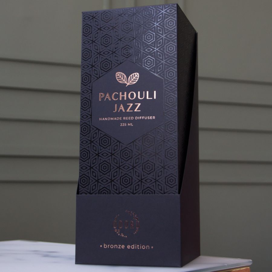 elegantly designed cardboard box for home fragrance on marble table, showcasing its luxurious appearance and intricate details against a neutral backdrop.