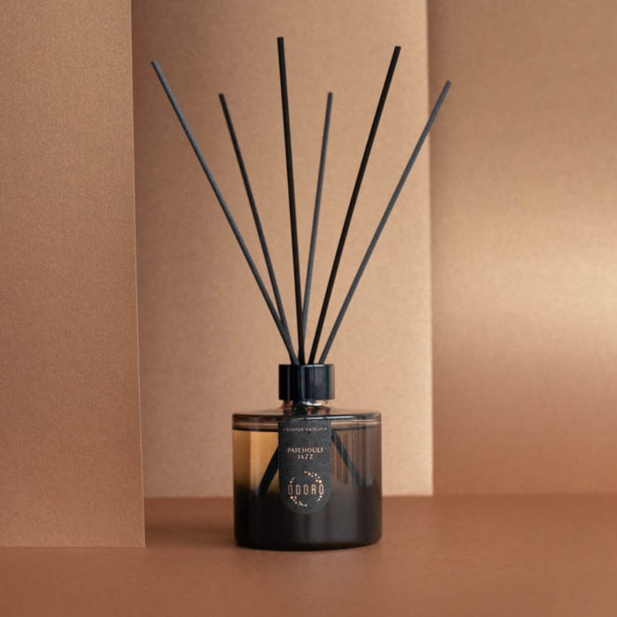 A stylish home fragrance bottle displayed against a soft nude backdrop, emphasizing its refined elegance and adding a touch of sophistication to the decor.
