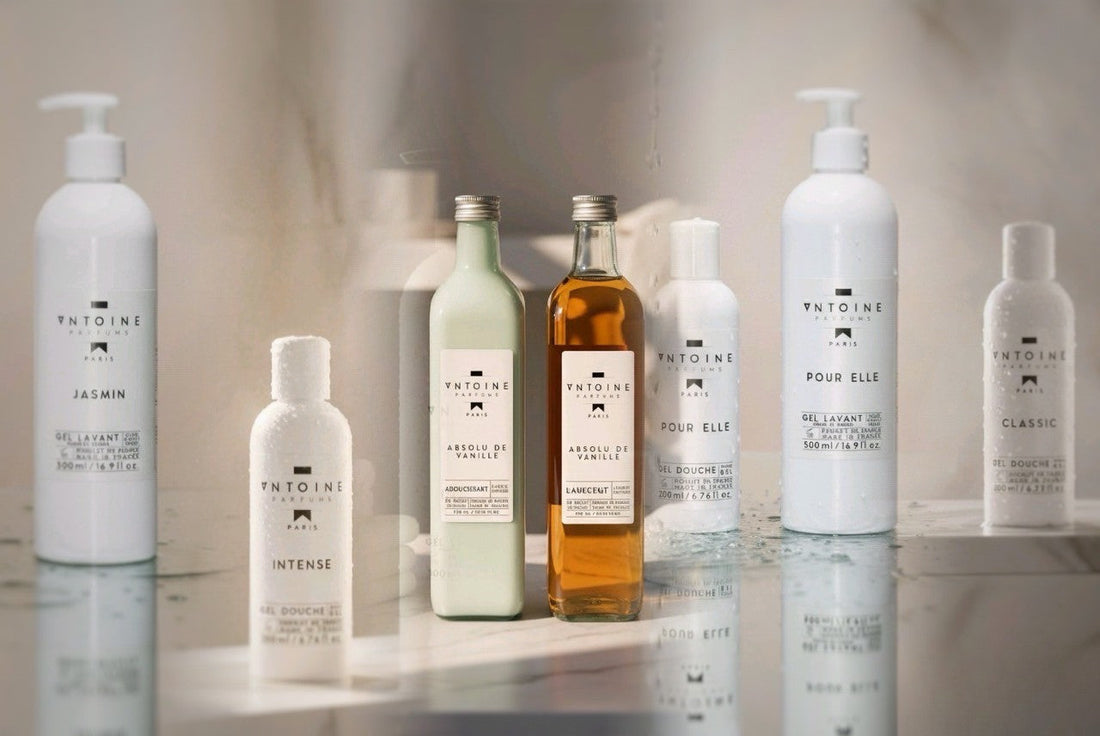 Antoine Parfums Absolu de Vanille collection — luxurious French perfumed laundry detergent, fabric softener, and body wash line including Jasmin, Intense, Pour Elle, and Classic variants, elegantly arranged on a marble surface