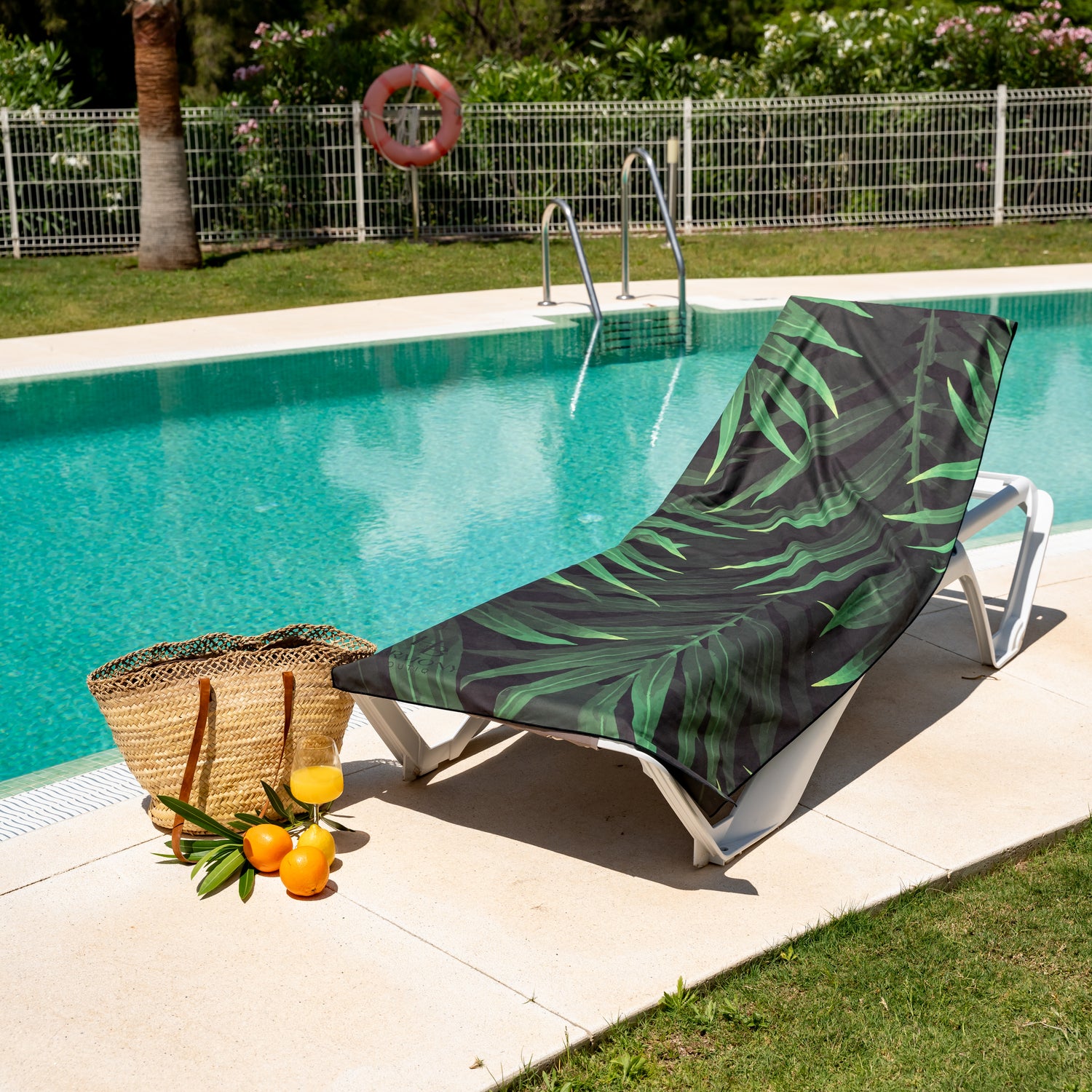 Full-size extra large Jungle Drift towel with tropical leaf print on poolside lounger – perfect for beach or vacation relaxation. Perfect holiday towel, compact, fast-drying, beautiful design
