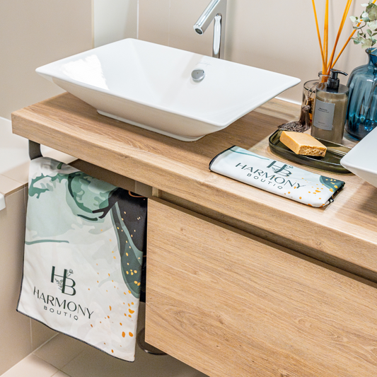 Bathroom view featuring Emerald Mist towel set – luxurious microfiber towels styled with wood cabinetry and elegant sink setup.
