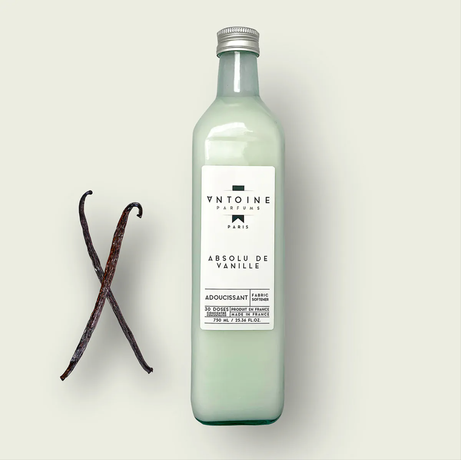 Antoine Parfums Absolu de Vanille fabric softener bottle with vanilla pods on beige background – luxury French perfumed softener from Harmony Boutiq.