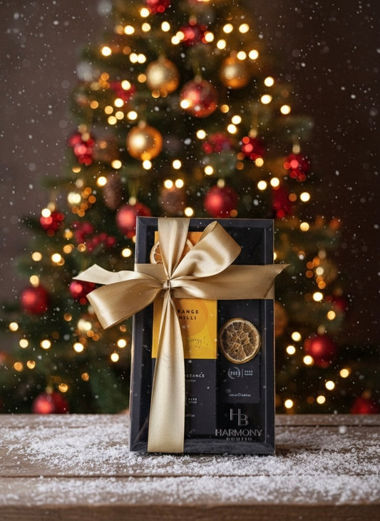Harmony Boutiq ODORO Chilli Orange gift set with home fragrance diffuser and room spray, placed in front of a Christmas tree with festive golden bow.