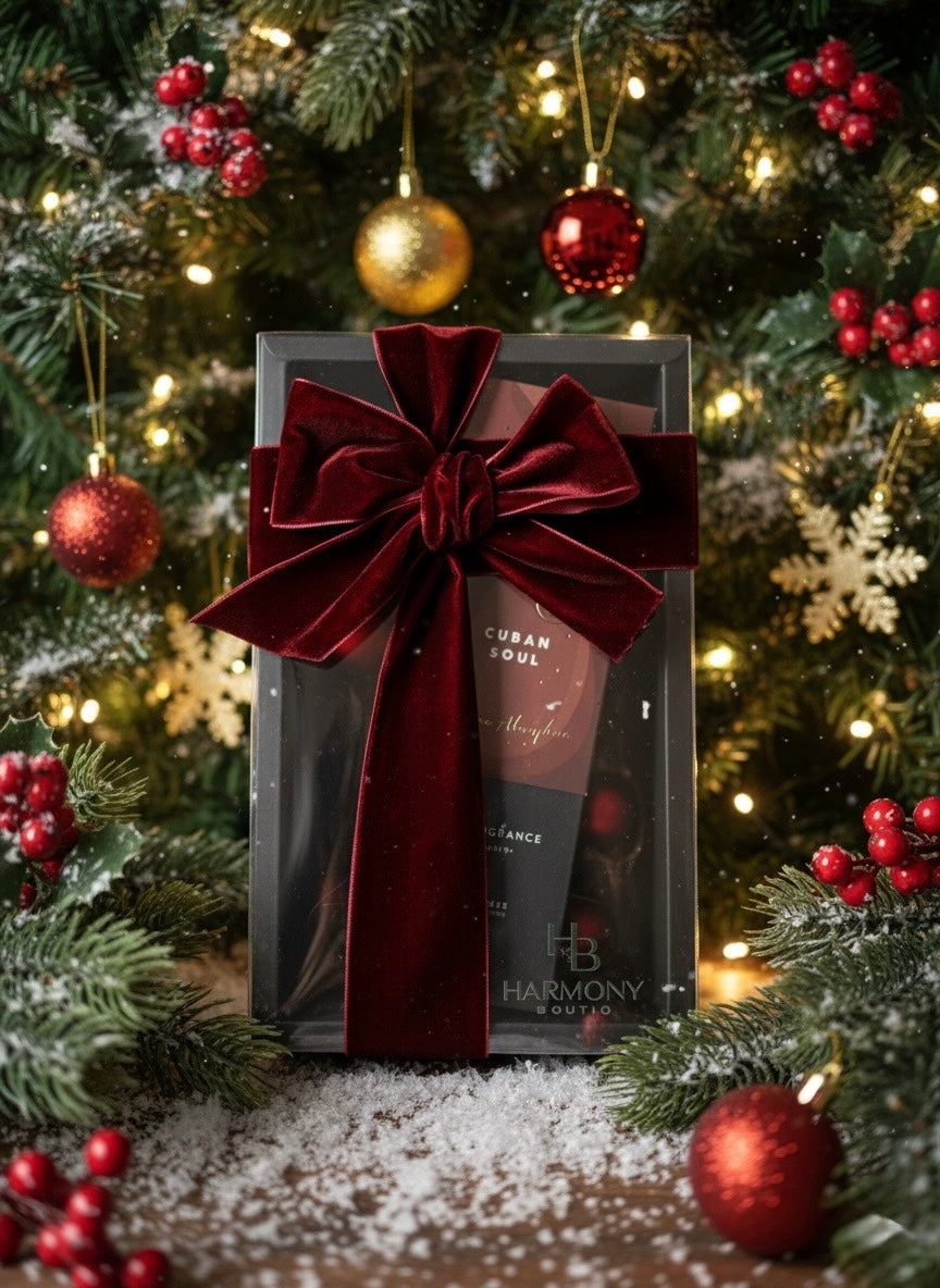 Harmony Boutiq ODORO Cuban Soul home fragrance gift set with diffuser, surrounded by Christmas decorations and a red velvet bow in a festive background.