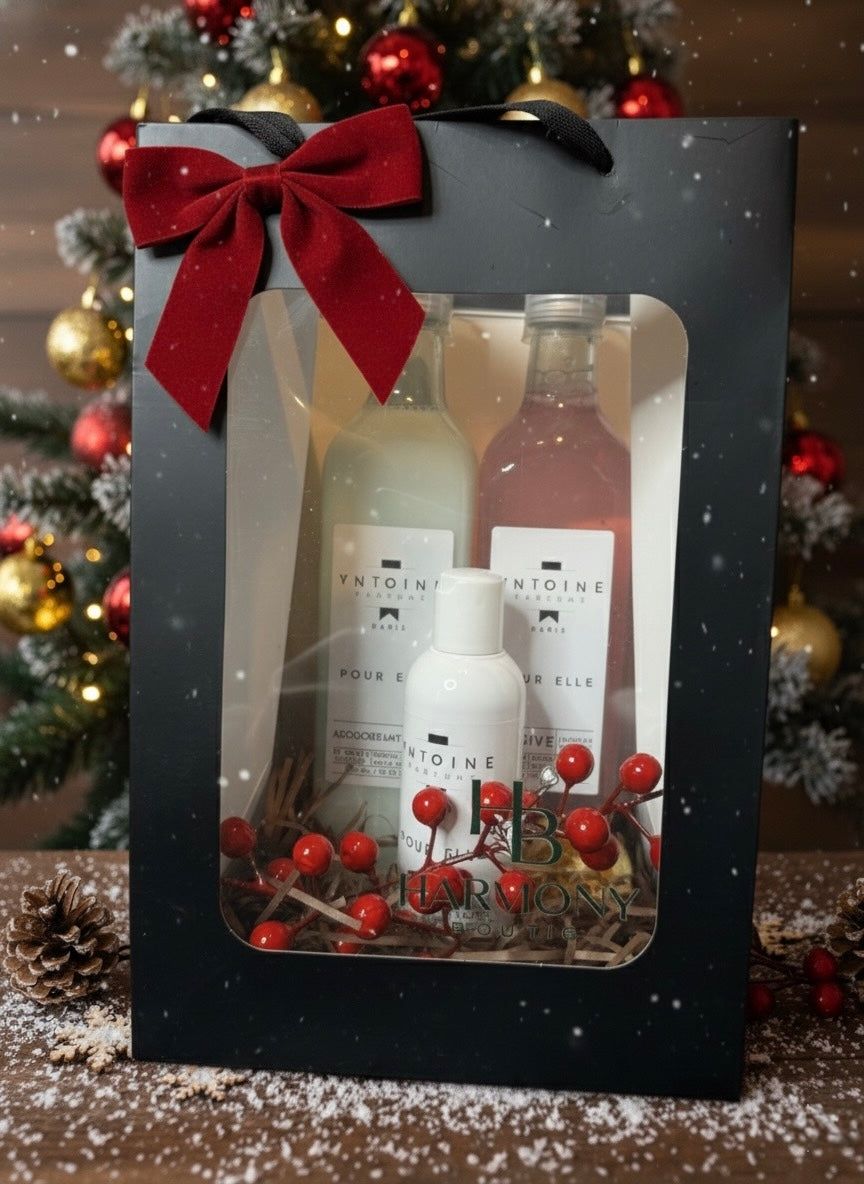 Harmony Boutiq Pour Elle gift set with perfumed laundry detergent, softener, and 200ml shower gel, elegant Christmas background with red bow and decorations.