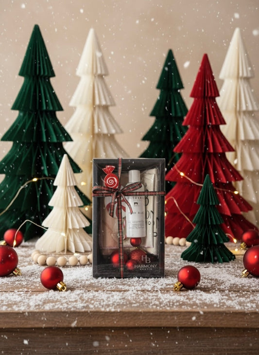 Harmony Boutiq Pour Elle gift set with perfumed shower gel and Rosé Vein microfiber towel set, elegant holiday background with Christmas decorations.