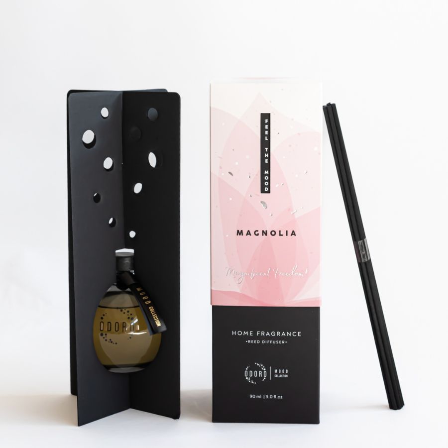 Unboxed Mood Collection Magnolia Home Fragrance diffuser bottle displayed with reed sticks and packaging, bringing elegance and fragrance to any space