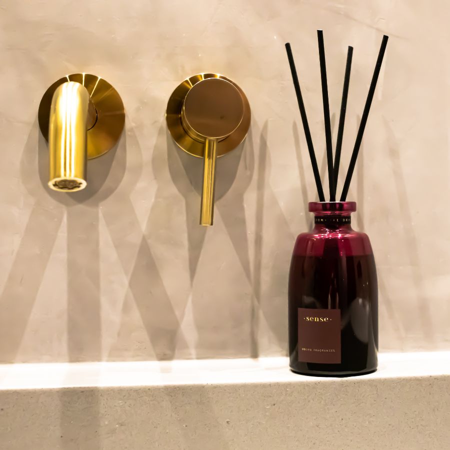 ODORO Sense Icon diffuser displayed in a luxurious bathroom with golden fixtures.