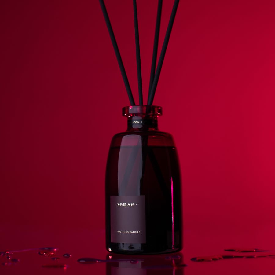 ODORO Sense Icon home diffuser with red wine, berries, and wood scent on a deep red background.