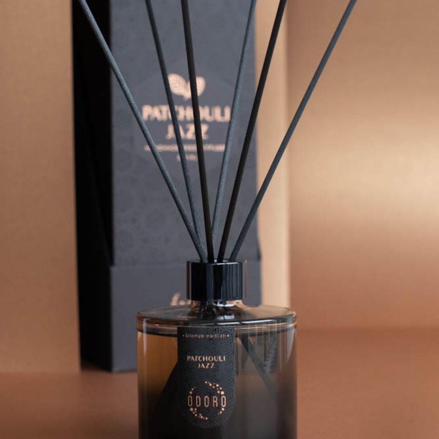 Elegant home fragrance bottle with sticks alongside its beautifully designed packaging, displayed against a neutral home backdrop, enhancing the overall aesthetic.