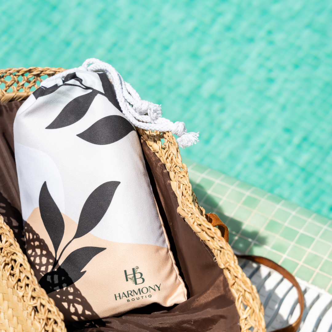 Ecovera towel pouch packed inside a straw beach bag by the pool – minimalist and convenient for on-the-go use.
